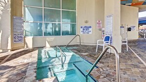 Piscina de aguas poco profundas donde no está permitido bucear, sin vigilantes presentes y con normas de la piscina exhibidas en las paredes.