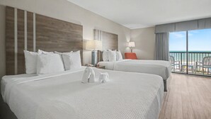 A hotel room with two beds, a balcony with a view, and a modern design. - Oceanfront Two Queen Room + Lazy River & Hot Tub (Myrtle Beach)