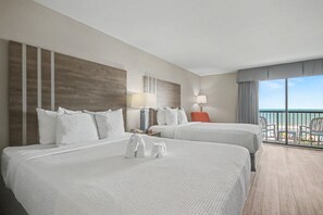 Habitación de hotel con dos camas, un balcón y vistas, y un diseño moderno.