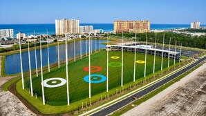 An aerial view of a sports complex with a large field, multiple tall poles, and a surrounding road. - Ocean Ritz 2001! Gulf Views, 4BR Penthouse Beachfront Escape (Panama City Beach)