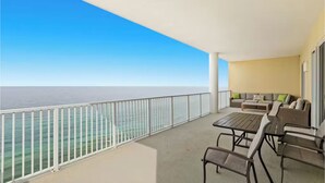 A balcony with a view of the sea, a sofa, and a table. - Ocean Ritz 2001! Gulf Views, 4BR Penthouse Beachfront Escape (Panama City Beach)