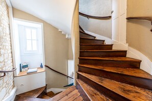 A wooden staircase with a white wall and a door leading to a room with a window. - Nadal - Dans l'hypercentre de Caen (Caen)