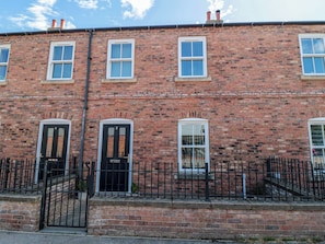 A red brick terraced house with three windows on the ground floor and two on the upper floor. - 3 Railway Terrace (Bridlington)