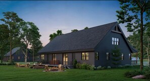 Una casa moderna con techo oscuro, ventanas amplias y un césped bien cuidado.