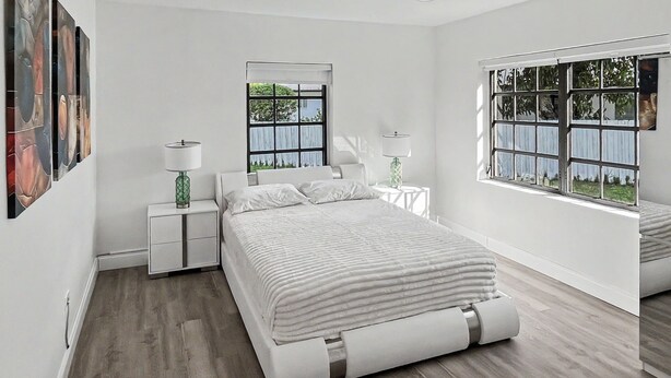 A modern bedroom with a large bed, two bedside tables, a window with a view, and artwork on the wall. - Brand New Private Guest House (Miami)