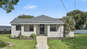 A single-story house with a front entrance, a small front yard, and a paved driveway. - Brand New Private Guest House (Miami)