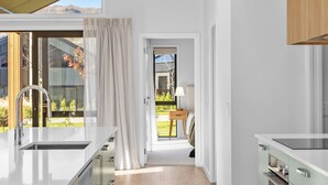 Eine moderne Küche mit einem großen Fenster, einer Spüle und einem Holzkasten.