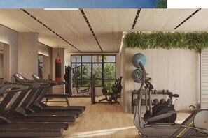 A modern gym with treadmills, weight machines, and a large window with a view of greenery. - Apartamento Confortável – Vila Olímpia (São Paulo)