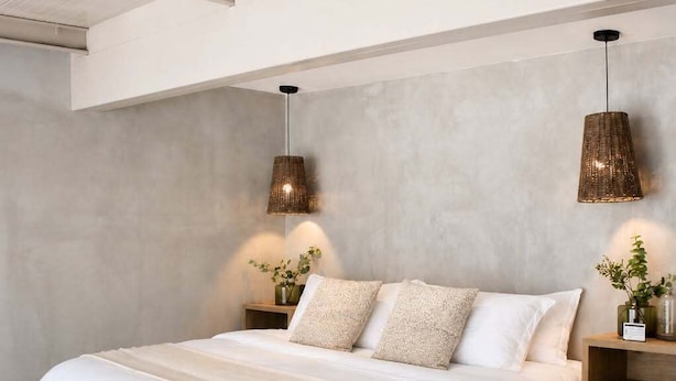 A modern bedroom with a large bed, two bedside tables, and hanging pendant lights. - SWEVEN Hotel Boutique (Guadalajara)