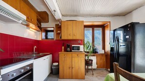 A compact kitchen with a microwave, stove, and refrigerator.