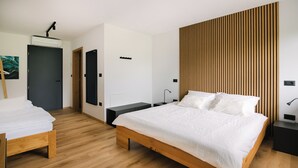 A modern bedroom with a wooden bed, a bench, a wall-mounted air conditioner, and a wooden slat wall panel.