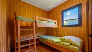A bunk bed room with a window and a ladder. - Single-story Holiday Home by the Pond no. 3 (Darlowo)