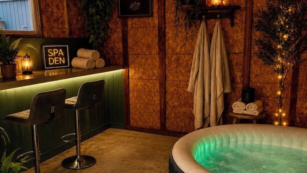 A spa area with a hot tub, wooden walls, and a sign that reads 'RELAX SOAK UNWIND.' -     Rustic Spa Escape Near I-70 (Goodland)