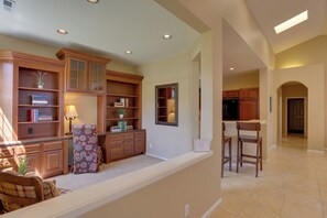 A spacious living area with built-in wooden cabinets, a comfortable seating area, and a kitchen with wooden cabinets. - Bend Home: Office, Garage, Parks, Seasonal Pool! (Bend)