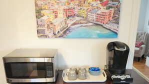 A kitchen counter with a microwave, coffee maker, and teapots. - Great House In Taylors Just Minutes To Downtown Greenville (Taylors)