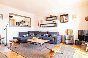 Ein modernes Wohnzimmer mit Sofa, Couchtisch und TV-Möbel.
