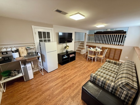 A compact living space with a kitchenette, dining area, and a sofa.. Quiet Private Suite Near MetLife Stadium