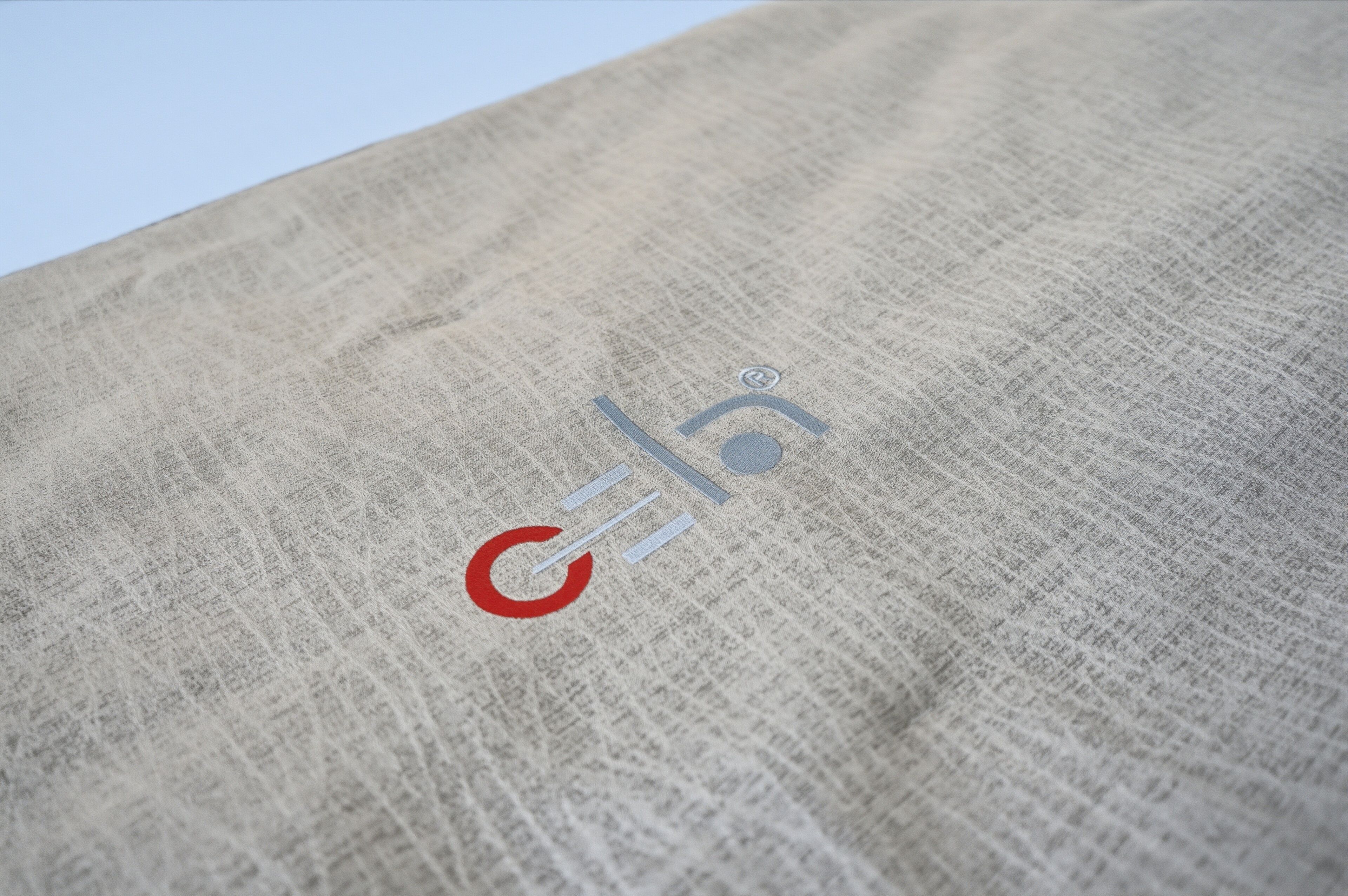 A close-up of a textured fabric with a logo.