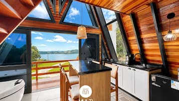 Honeymoon Chalet | Private kitchen | Fridge, microwave, cookware/dishes/utensils, dining tables