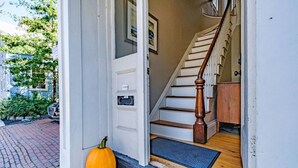 A house entrance with a wooden staircase, a mailbox, and a pumpkin on the steps. - Prime Location, Private Rooftop Deck.Walk to Old Port,waterfront, Museums& Music (Portland)
