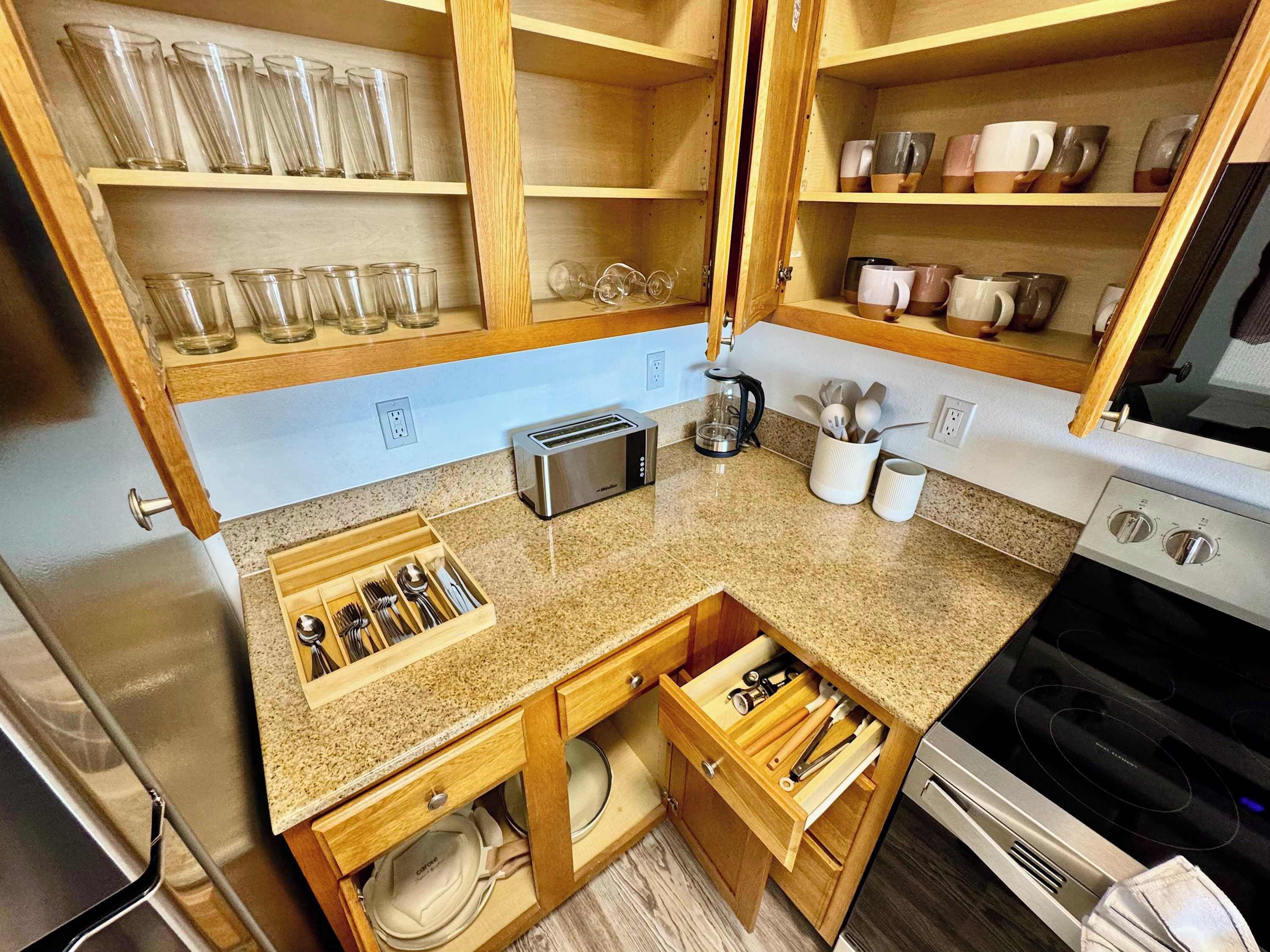 A kitchen with wooden cabinets, a built-in toaster, and a coffee maker.