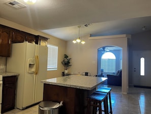 A kitchen with a refrigerator, a sink, a countertop, and a window. - perfect stay in best small town (Somerton)