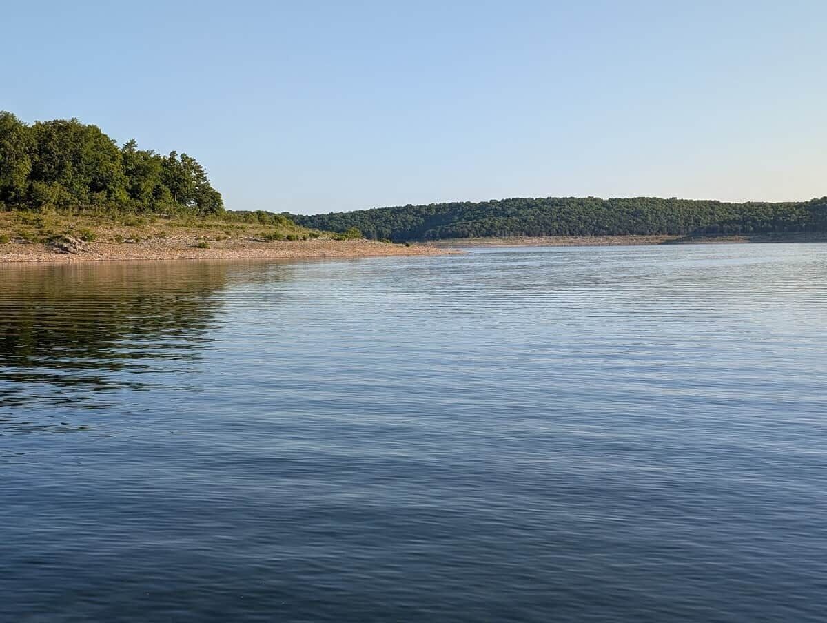A calm lake with a forested shoreline.
