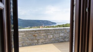 A stone wall and a view of a coastal landscape. - Mani Stone Tower– Sea & Mountain Escape by ΜΡS (Oitylo)