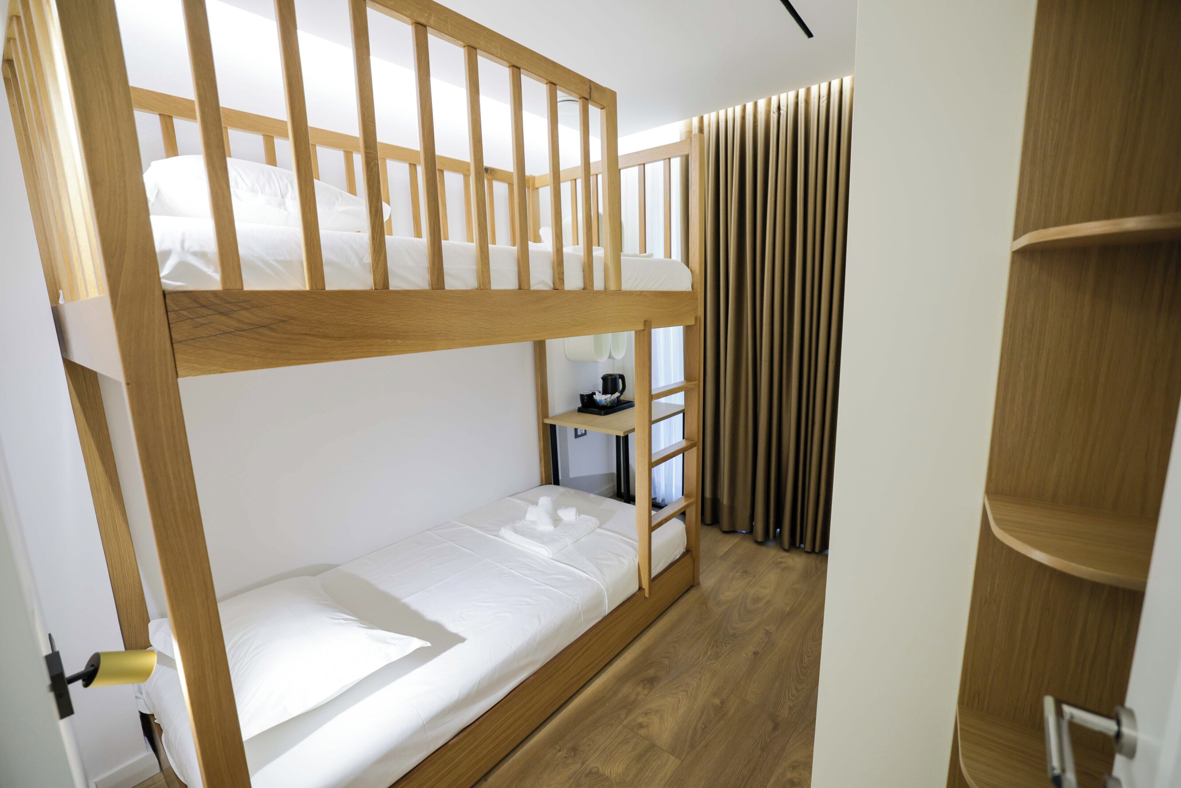 Family Twin Room | In-room safe, laptop workspace, blackout drapes, iron/ironing board