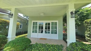A house with a covered porch, a white door, and a welcome mat. - Aob-oun Homestay By Zuzu (Pak Chong)