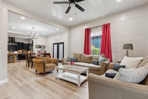 A spacious living area with a dining table, sofas, and a ceiling fan. - Dallas- Central Location, Spacious Backyard- Pets Welcomed (Dallas)