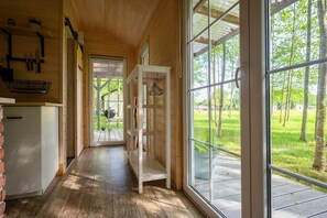 A wooden interior with a large glass door leading to an outdoor area. - Comfortable Holiday Home no. 4B With a Fireplace (Darlowo)
