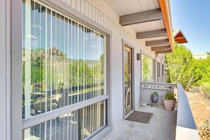 A modern building with large windows, a covered porch, and potted plants. - Sedona Wellness Retreat Near Trails & Downtown (Sedona)