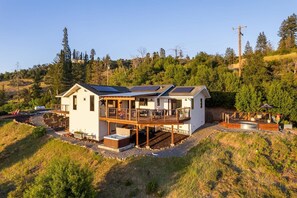 A two-story house with a deck, solar panels, and a hot tub. - Alta Mayacama | Views, Hot Tub, Plunge Pool (Santa Rosa)