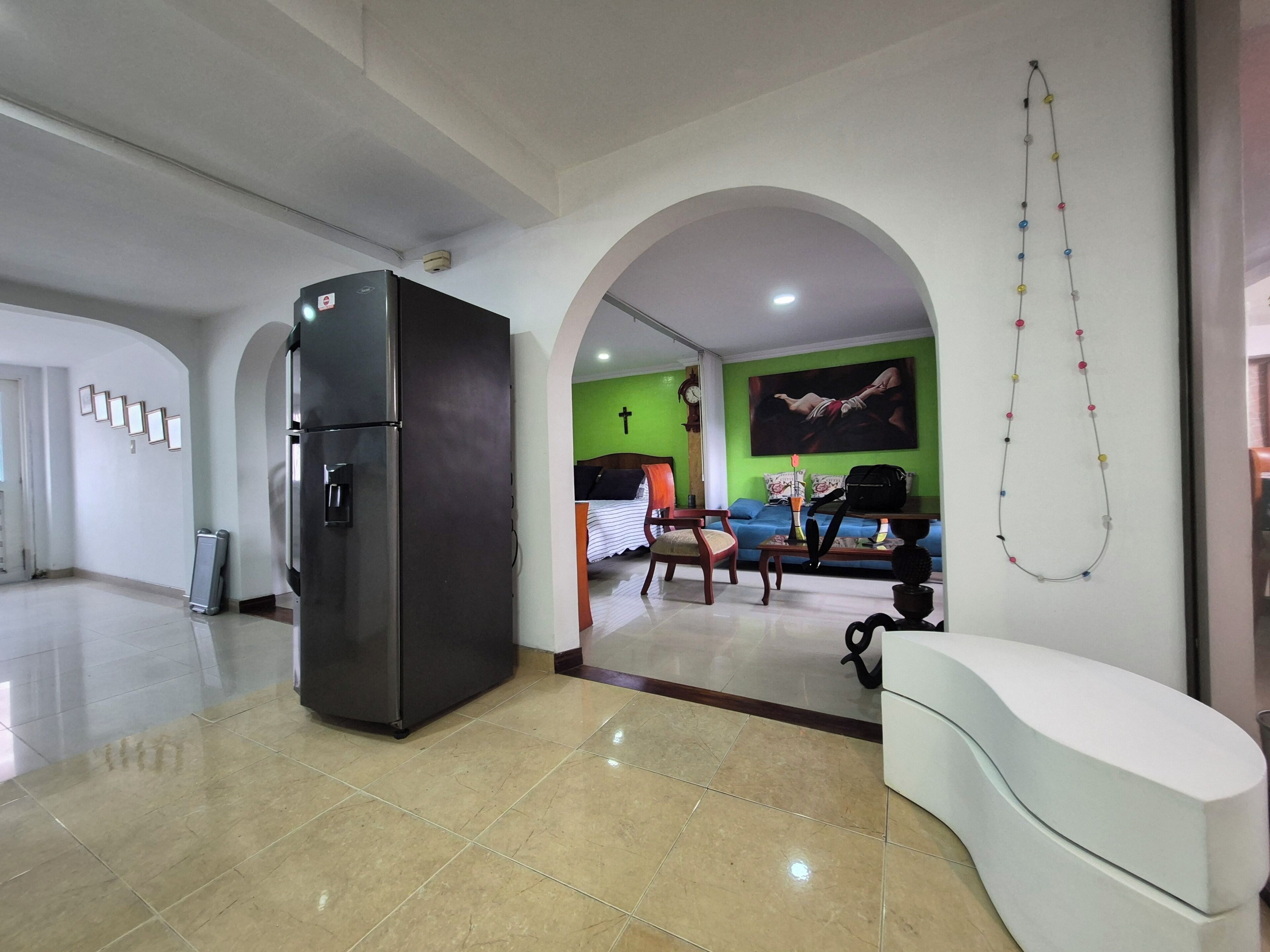 A spacious living area with a modern kitchen, a dining area, and a seating space.