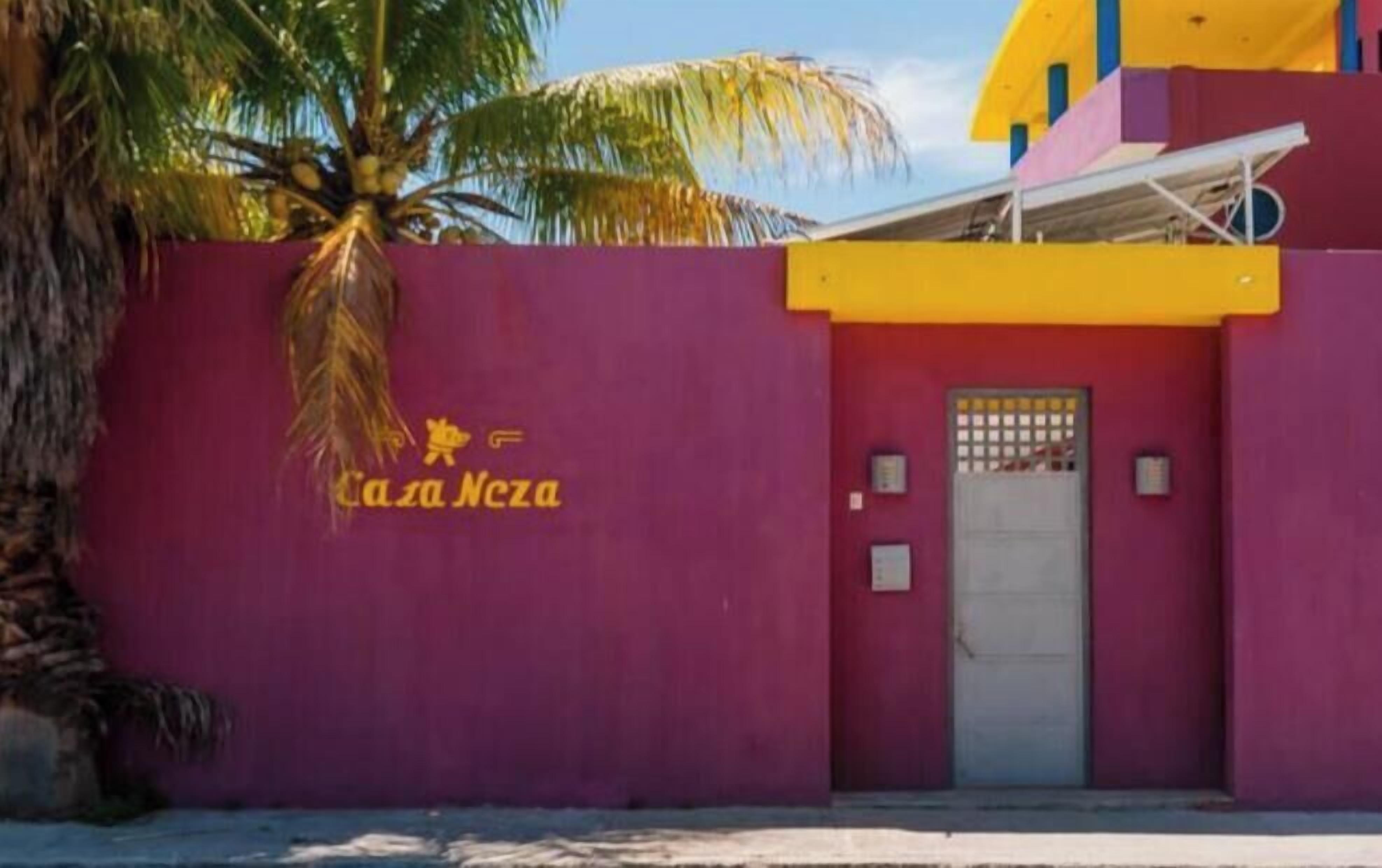 A building with a purple wall and a yellow roof.