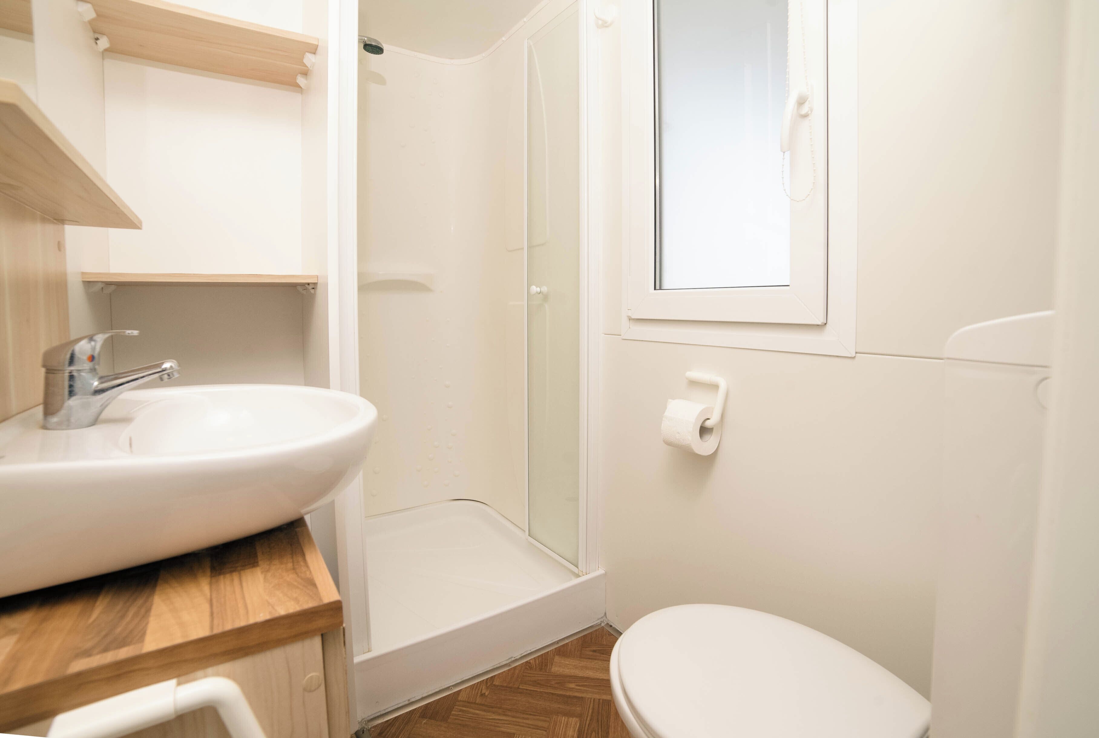 A bathroom with a sink, toilet, and shower.