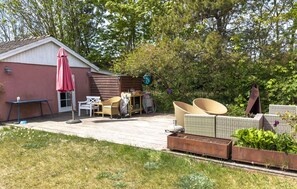 A patio with outdoor furniture, a shed, and a garden area. - Amazing home in Glesborg with WiFi (Glesborg)