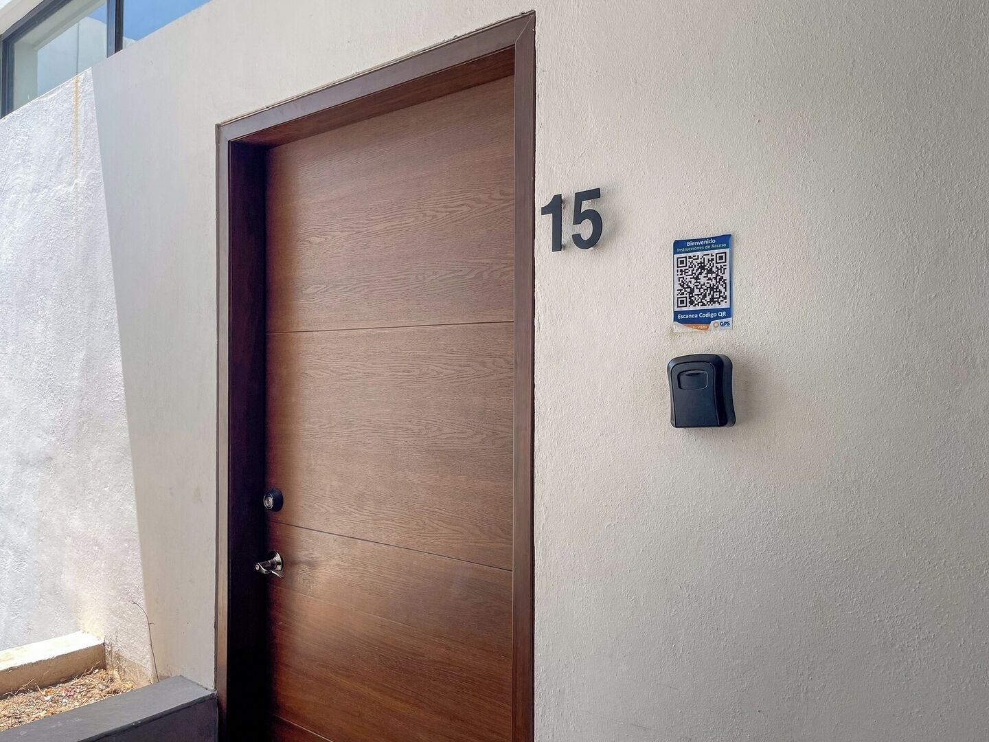 A wooden door with a number '15' on the wall beside it.