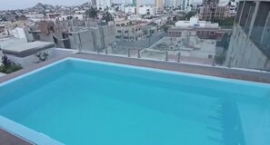 A rooftop pool with a cityscape view. - Beautiful apartment 3 blocks from the beach (Mazatlan)
