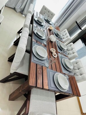 A dining table set with plates, glasses, and a centerpiece. - Beautiful apartment 3 blocks from the beach (Mazatlan)