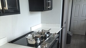 A kitchen with a stove, oven, and cabinets. - Stylish apartment close to attractions, dining, shopping, and entertainment (Montego Bay)