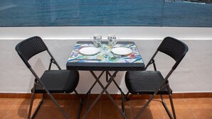 A balcony with a table set for two, overlooking the sea. - Front line beach penthouse with large terrace facing the sea! (Puerto de la Cruz)