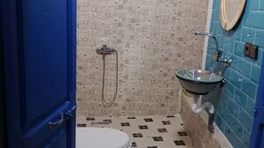 A bathroom with a toilet, a sink, and a shower.