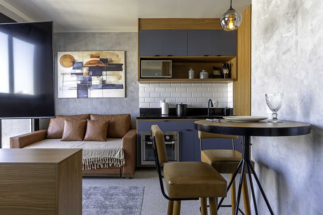 Un salon moderne comprenant un canapé, une table basse et un coin repas avec des chaises et une table.