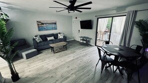 Una sala de estar moderna con un sofá, una mesa de centro y una mesa de comedor.