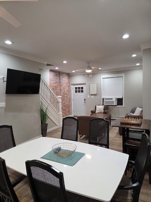 A dining area with a white table, black chairs, and a chessboard. -  Shore Getaway. 3-bedroom  house in Fantastic Atlantic City very close Boardwalk (Atlantic City)