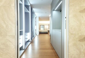 A modern hallway with built-in shelving, a wooden floor, and a bed in the distance. - Stunning 160m² Designer Loft in Estrela | Luxury Living in Lisbon (Lisboa)