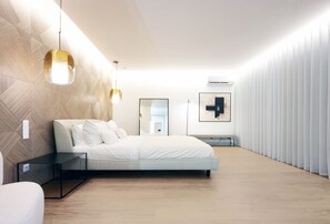 A modern bedroom with a bed, bedside tables, a wall-mounted light fixture, and a large window. - Stunning 160m² Designer Loft in Estrela | Luxury Living in Lisbon (Lisboa)