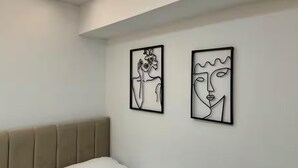 A bedroom with a bed, a headboard, and two abstract art pieces on the wall. - Dajti National Park House, Sleeps 7 With Aircon (Tirana)